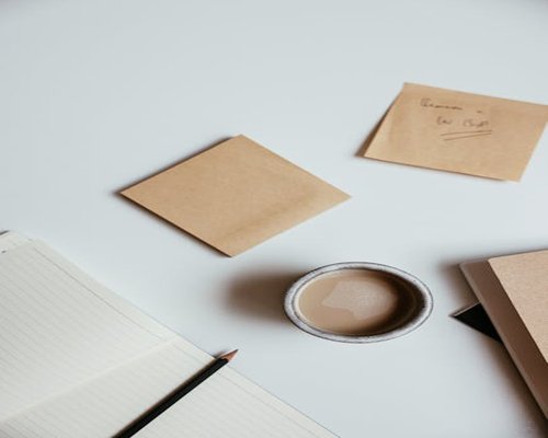 A cup of coffee and notes on a desk at the editorial office