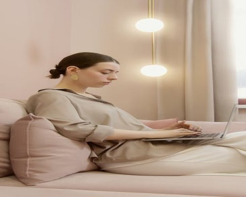 Woman focusing on laptop screen maintaining good posture
